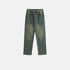 A flat-lay of a pair of vintage-washed loose-fit denim jeans with a worn look, laid against a white background
