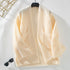 Cream colored oversized cardigan on hanger, featuring same chevron knit pattern and patch pockets