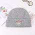 Light gray knit beanie featuring jumping puppy logo and red branding