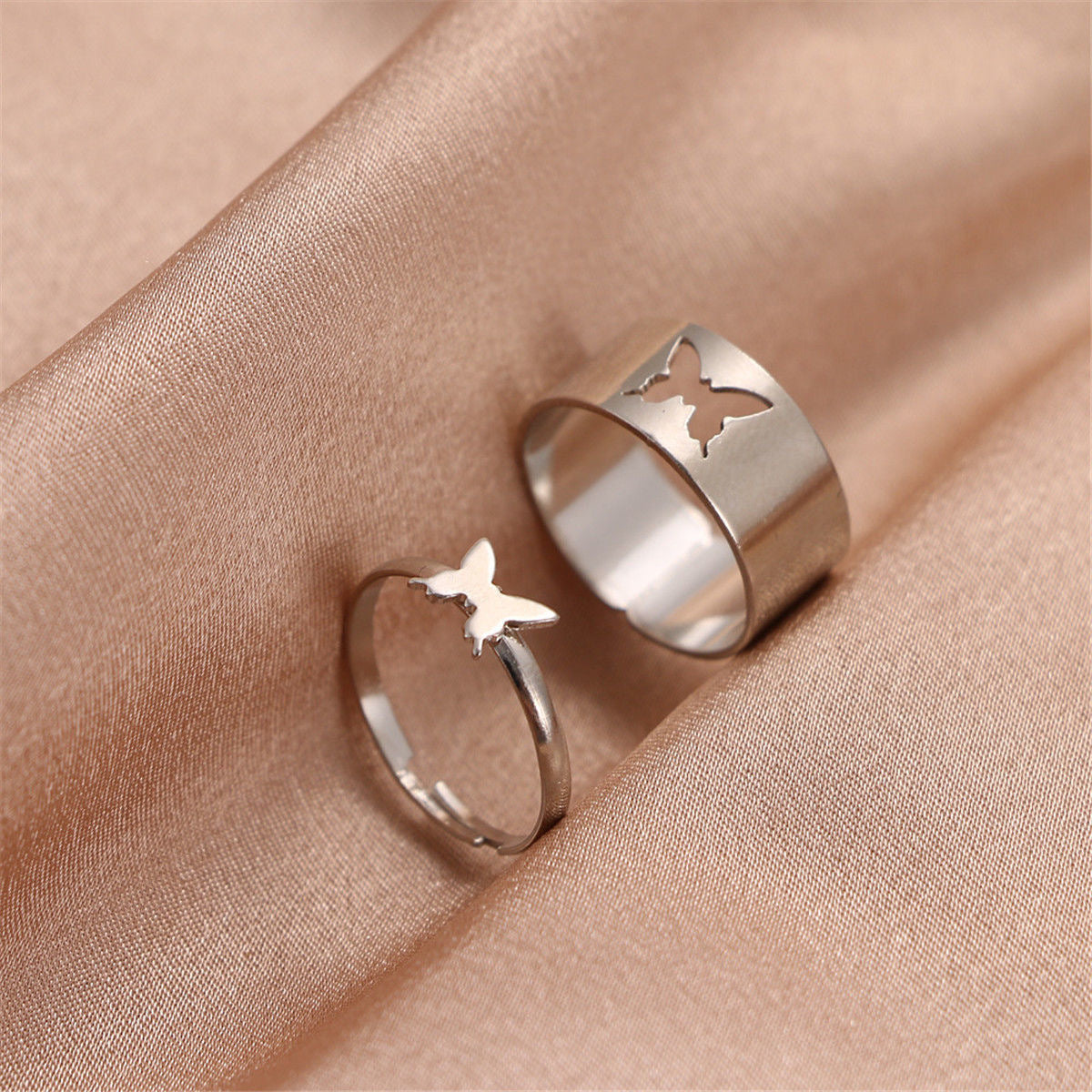 Silver butterfly rings on silk: matching set with wide cutout band and dainty butterfly band