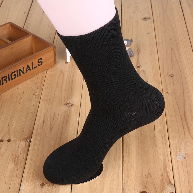 Light gray cotton crew sock displayed on white mannequin leg against wooden background