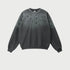 Gray sweatshirt with black paint splatter pattern concentrated at top
