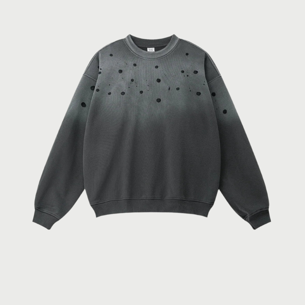 Gray sweatshirt with black paint splatter pattern concentrated at top