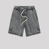 A pair of charcoal washed drawstring shorts with a relaxed fit, elastic waistband, and stitched hem details