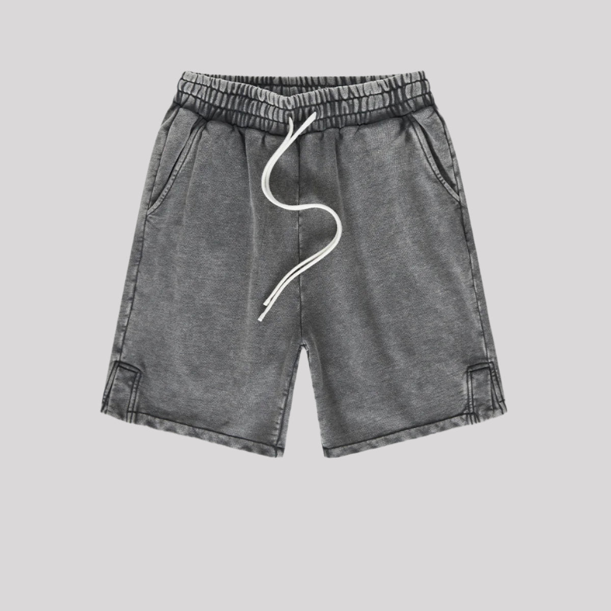 A pair of charcoal washed drawstring shorts with a relaxed fit, elastic waistband, and stitched hem details
