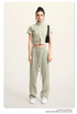 Sage green cropped jacket and wide-leg pants set with white sneakers