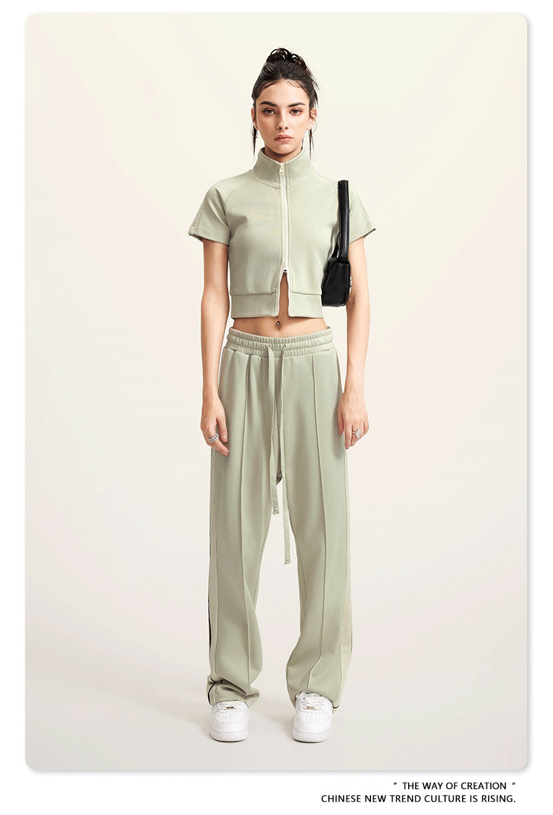 Sage green cropped jacket and wide-leg pants set with white sneakers