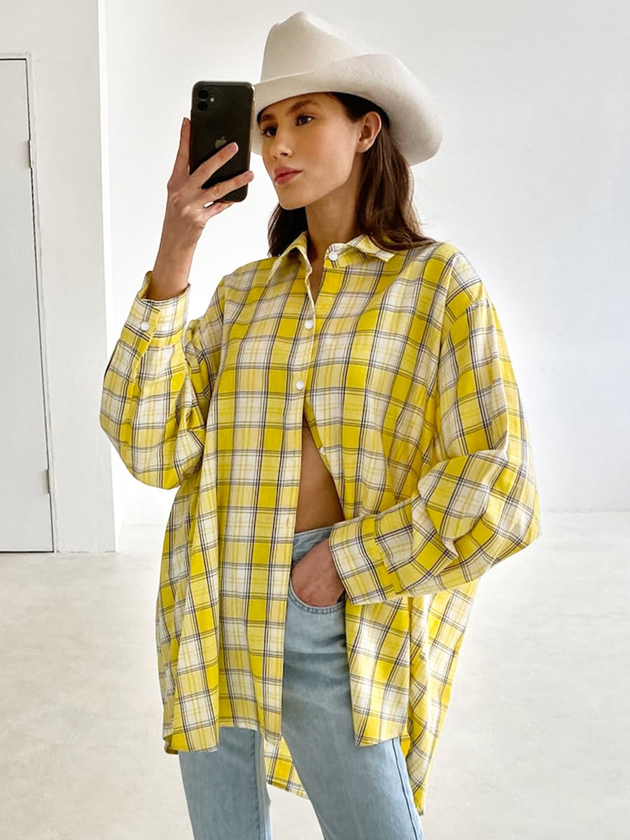 Woman in yellow plaid shirt taking selfie, wearing white cowboy hat