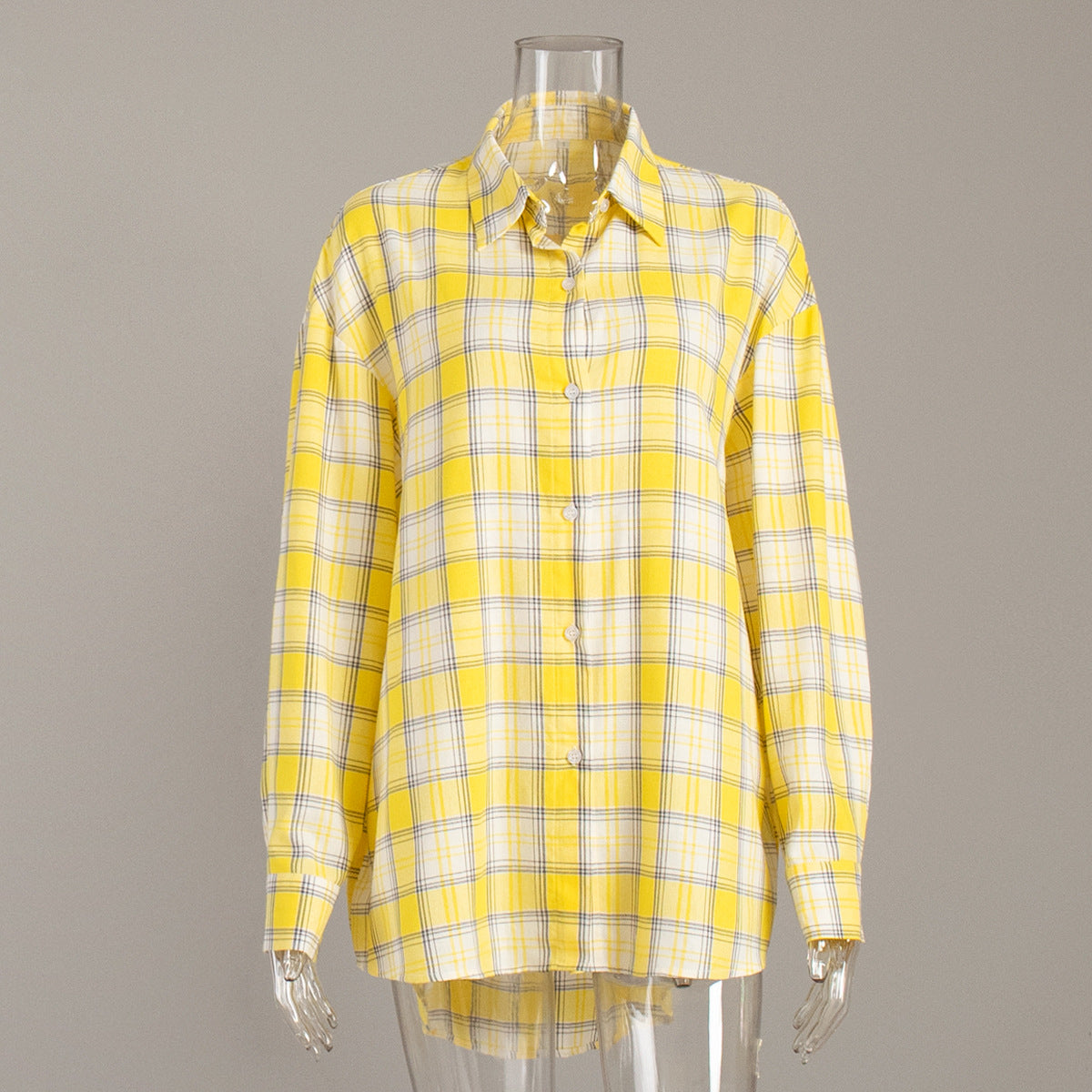 Detailed view of yellow plaid shirt collar and button placket
