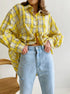 Cropped yellow plaid shirt worn with light wash denim, emphasizing loose silhouette
