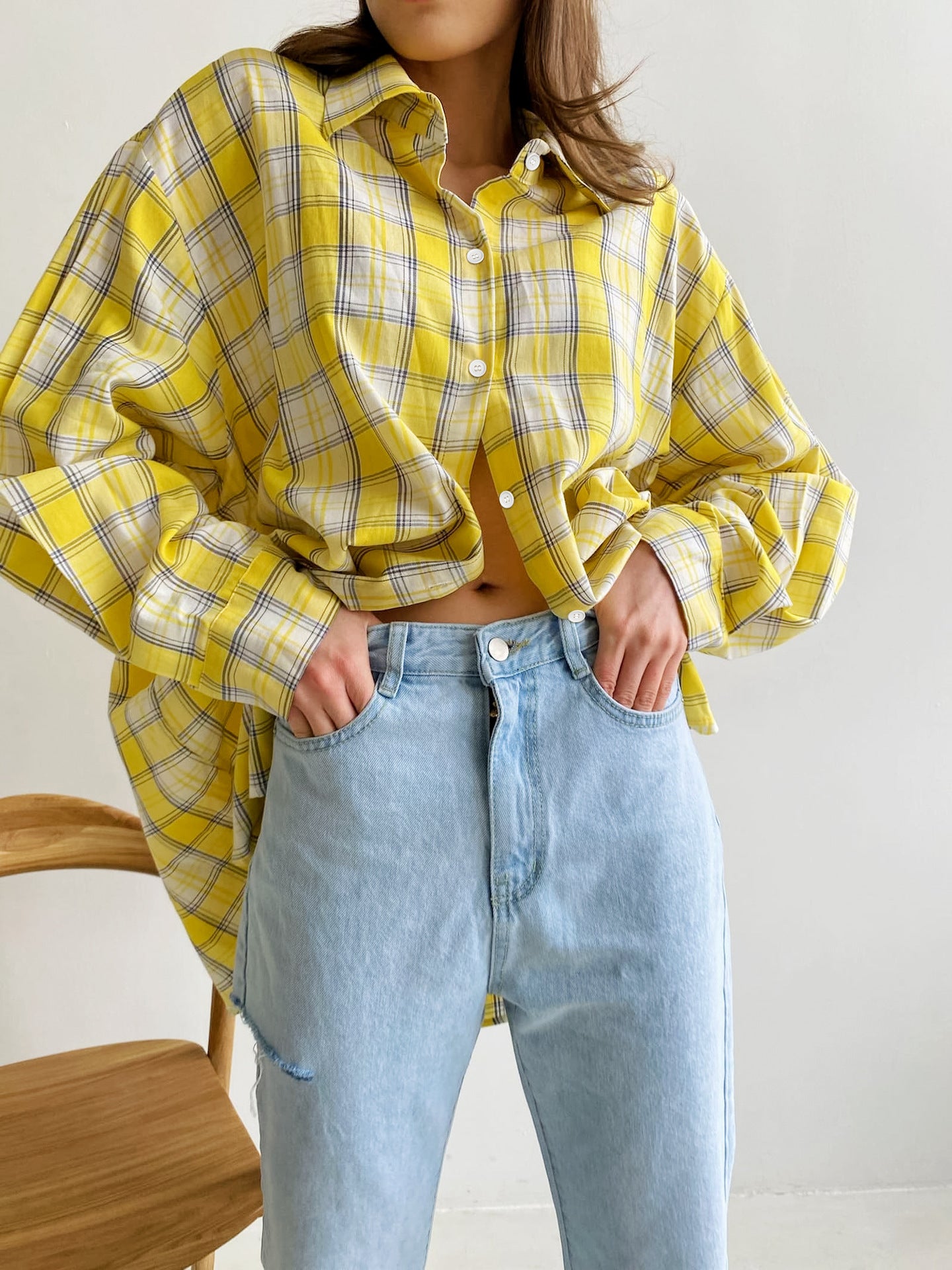 Cropped yellow plaid shirt worn with light wash denim, emphasizing loose silhouette