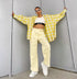 Styled outfit with yellow plaid shirt, white crop top, and light yellow wide-leg jeans