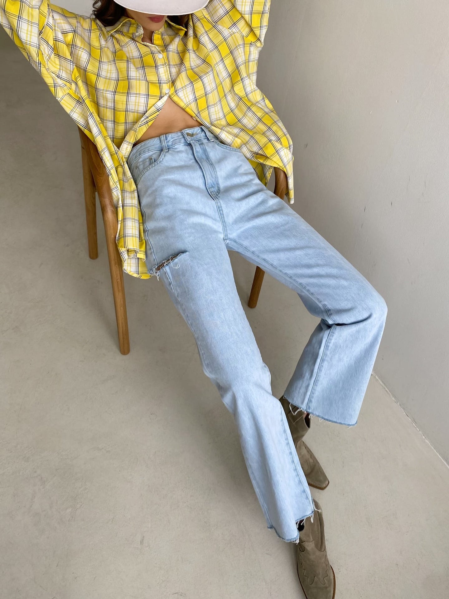 Close-up of yellow and white plaid shirt fabric with button details