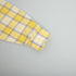Buttoned yellow plaid shirt fabric with crisp check pattern