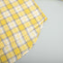 Yellow plaid shirt fabric with overlapping layers and check pattern
