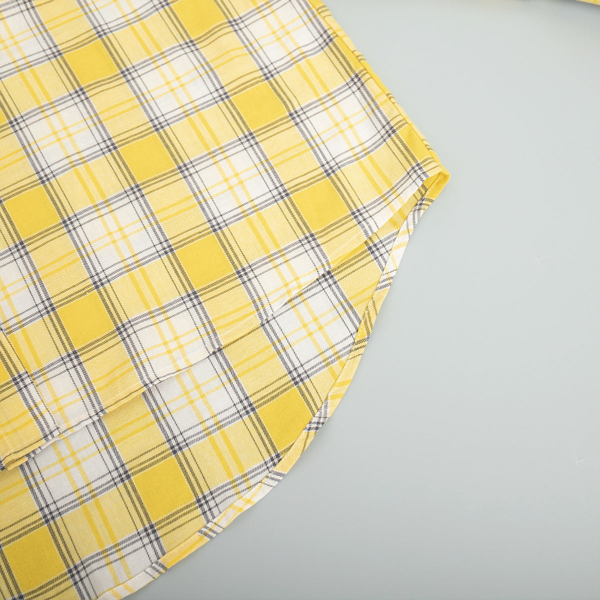 Yellow plaid shirt fabric with overlapping layers and check pattern