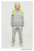 Model with platinum hair and neon yellow braids wearing an oversized gray sweatsuit featuring hoodie and matching joggers