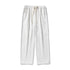 A model is standing in white wide-leg lounge pants with elastic waistband, drawstring closure and diagonal seam details on a plain background