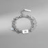 Pisces zodiac bracelet in silver-tone stainless steel, featuring a layered chain design and an engraved charm.