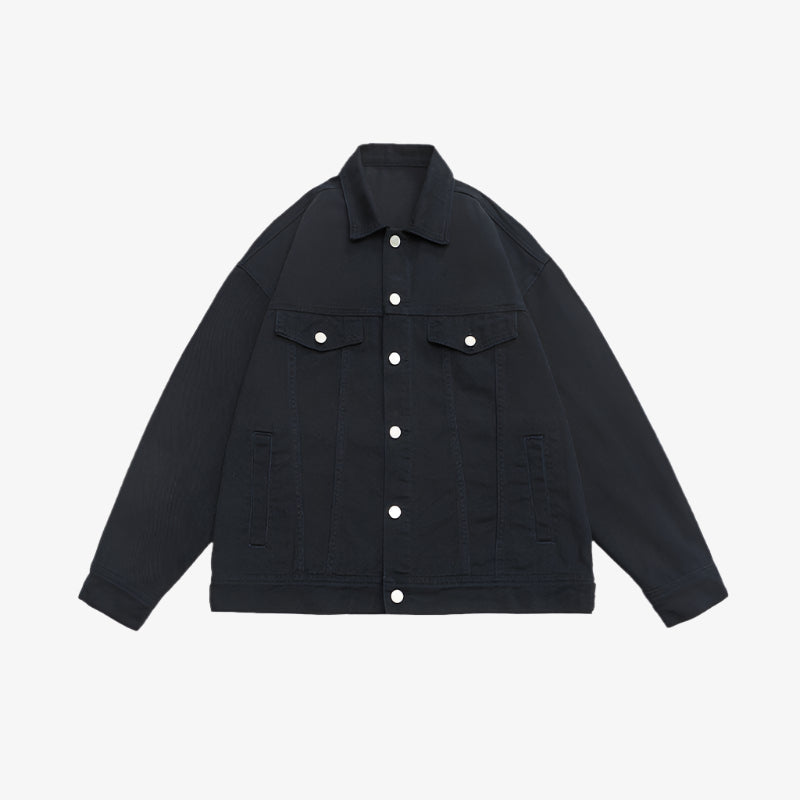 Black denim jacket with contrasting silver buttons and dual chest pockets displayed flat against white background