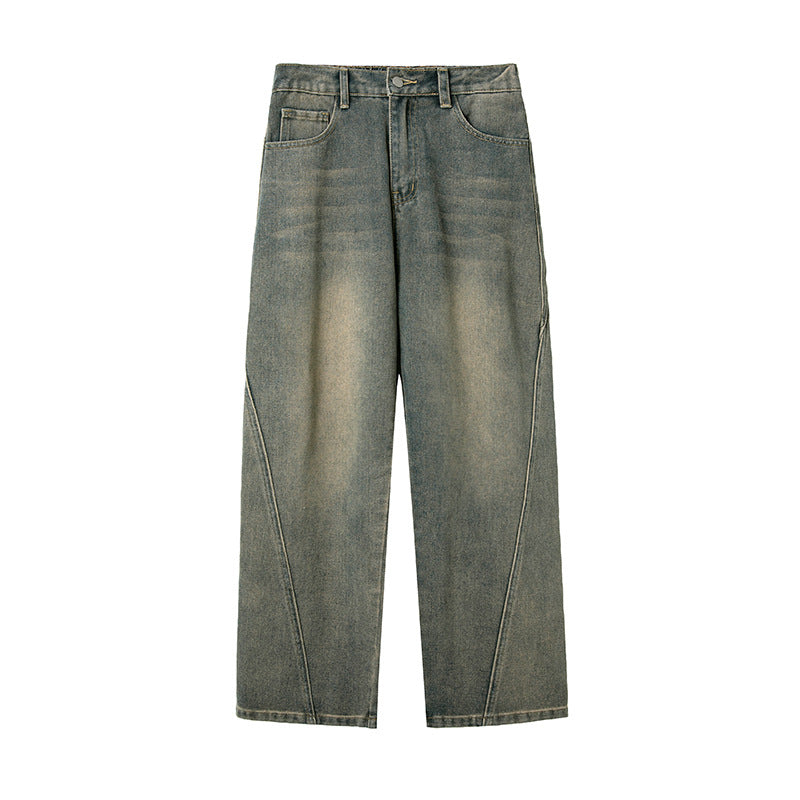 Flat lay of olive-green wide-leg jeans featuring unique curved seam detailing, faded wash effect, traditional five-pocket design, and button closure