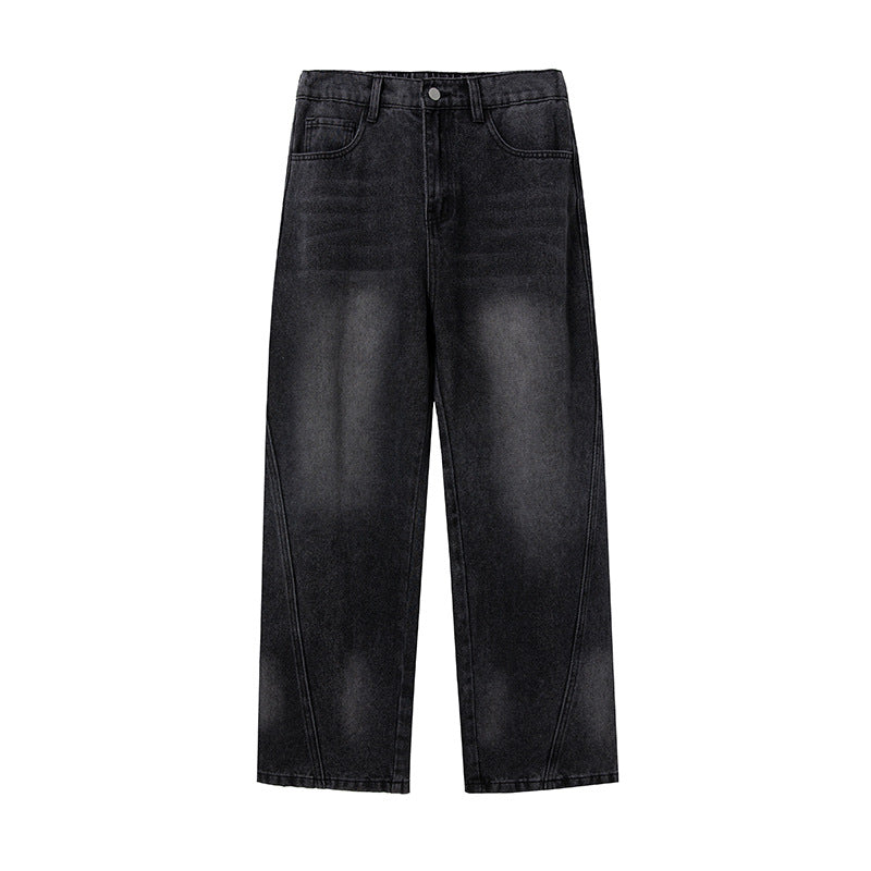 Flat lay of black wide-leg jeans with distinctive curved seam details, faded center effect, five-pocket design, and traditional button closure
