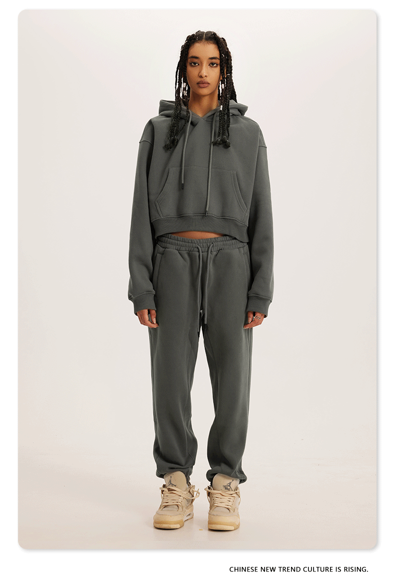 Charcoal Grey Sweatshirt and Joggers Set – Model in a dark grey hoodie and joggers, paired with beige sneakers