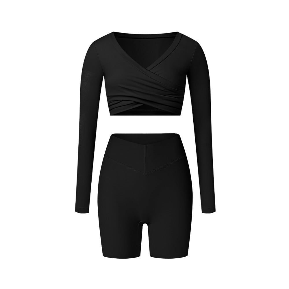 Black workout set with black wrap top and fitted shorts, featuring sleek design and compression fit