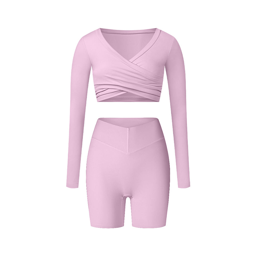 Pink workout set with wrap top and fitted shorts, displaying soft color and form-fitting design