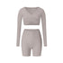 Gray athletic set with wrap top and shorts, showing neutral tone and seamless construction