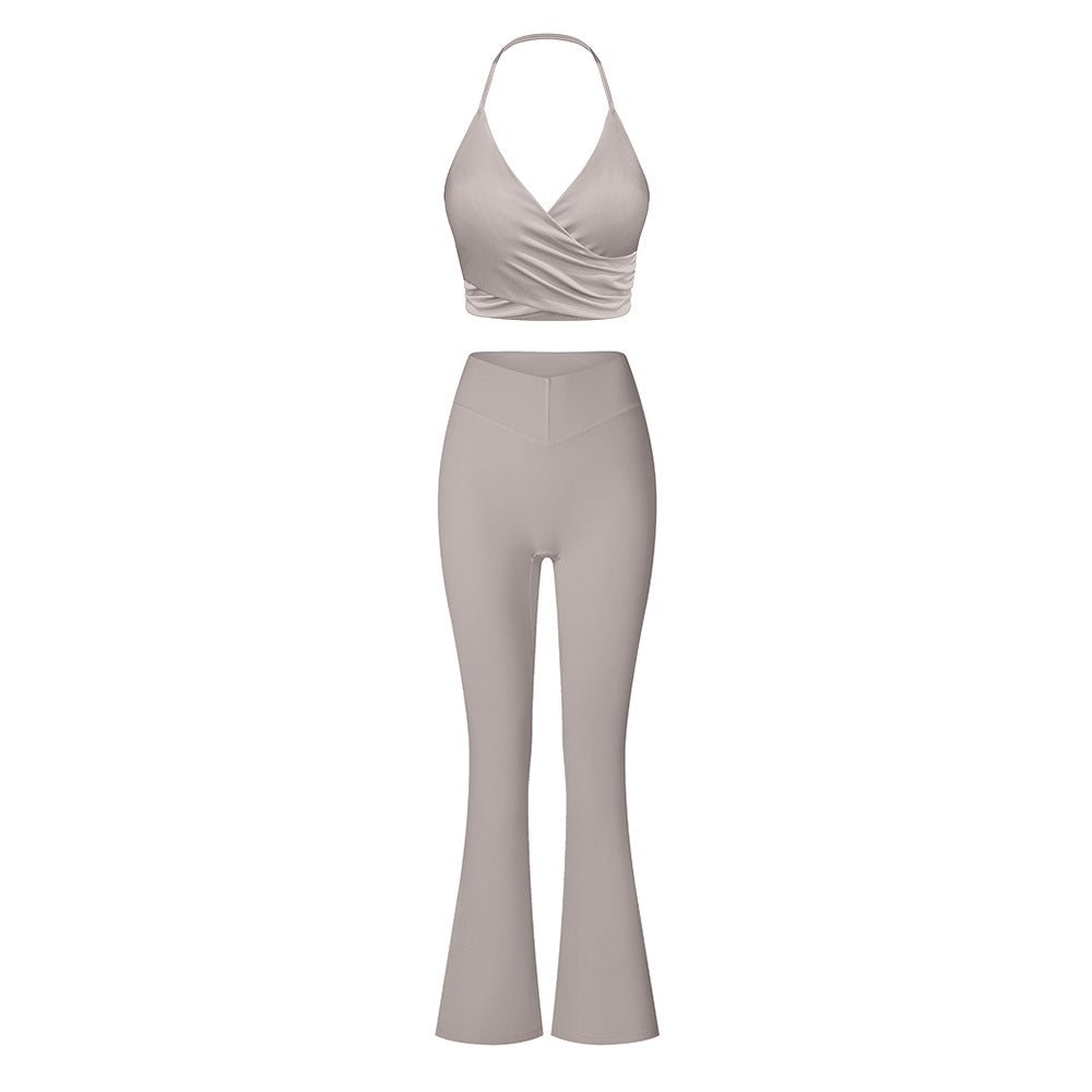 Gray/taupe halter neck workout set with ruched wrap sports bra and flared leggings featuring high-waist compression fit