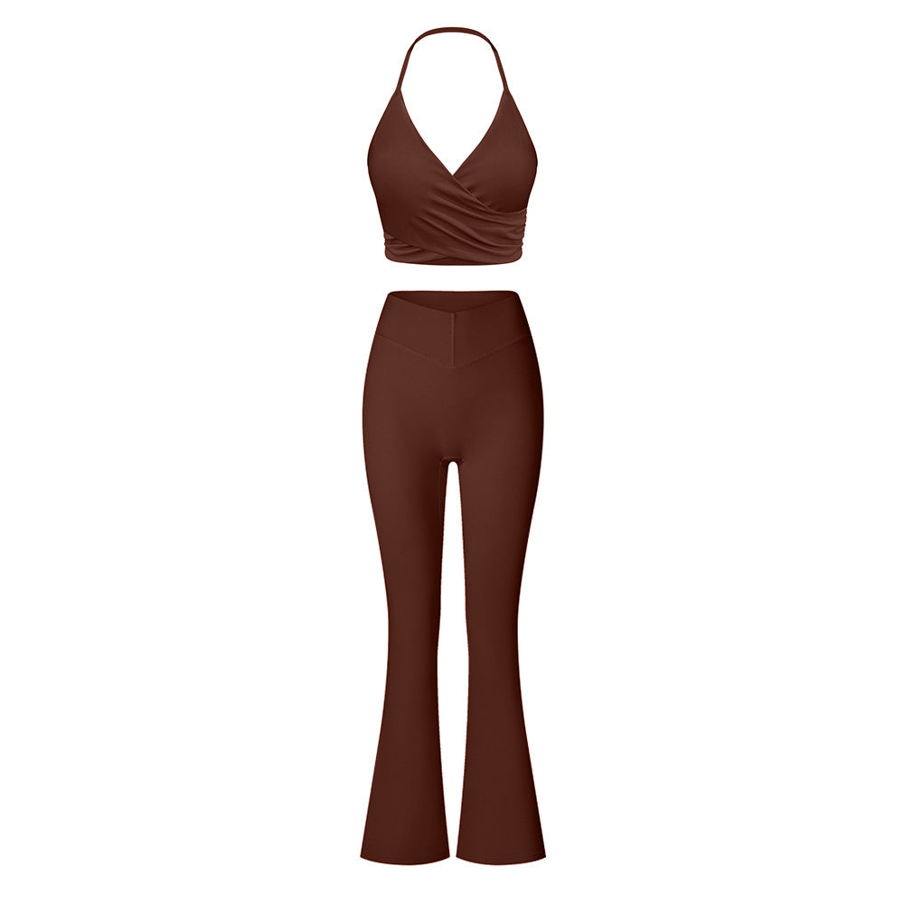 Rich brown two-piece athletic set combining halter crop top with wrap detail and high-waisted flared yoga pants