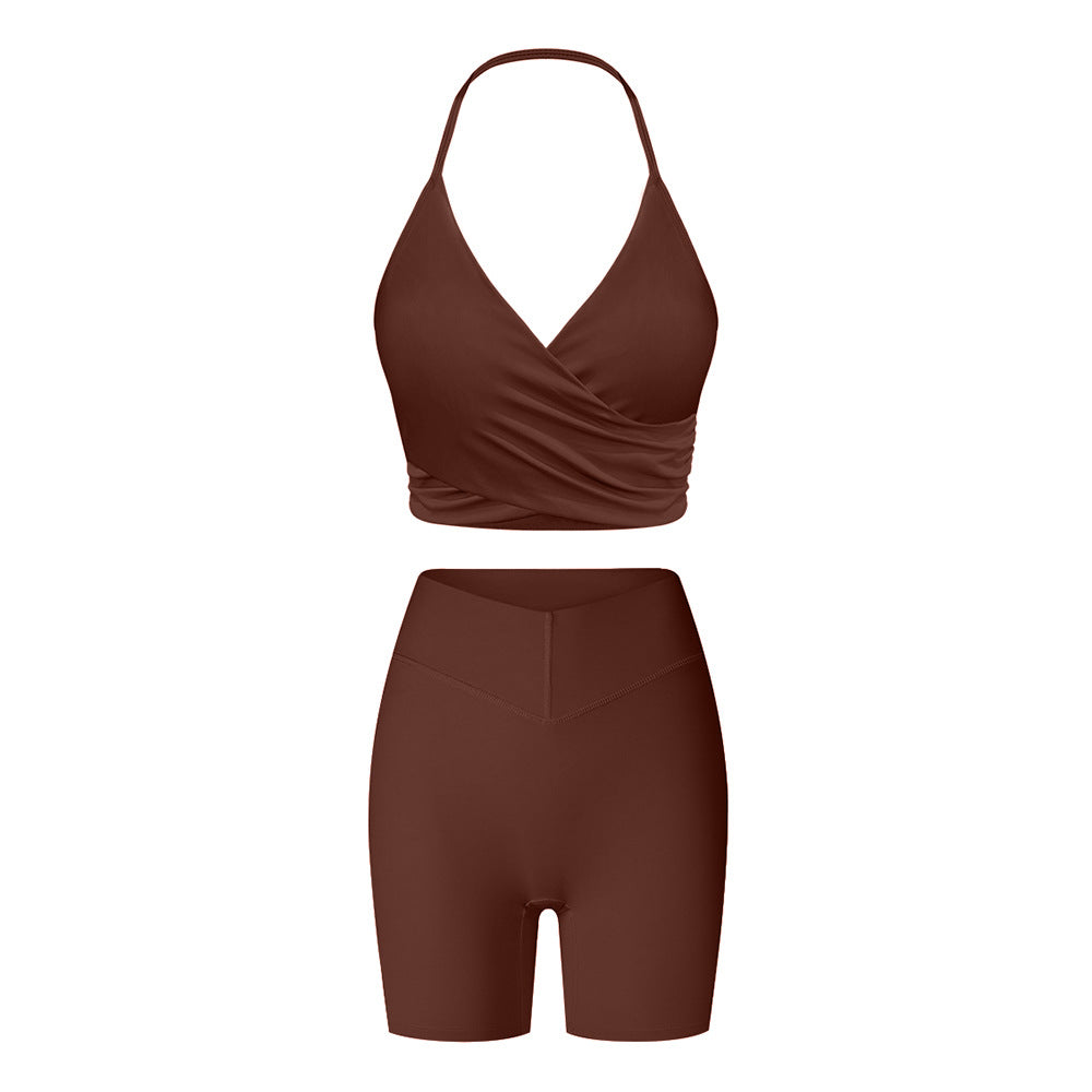 Brown workout set featuring halter wrap sports bra and high-waisted compression shorts