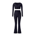Black workout set with long sleeve wrap top and flared pants, featuring classic design and stretch fabric