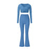 Blue athletic set with long sleeve wrap top and flared pants, showing v-neck detail and high-waist fit
