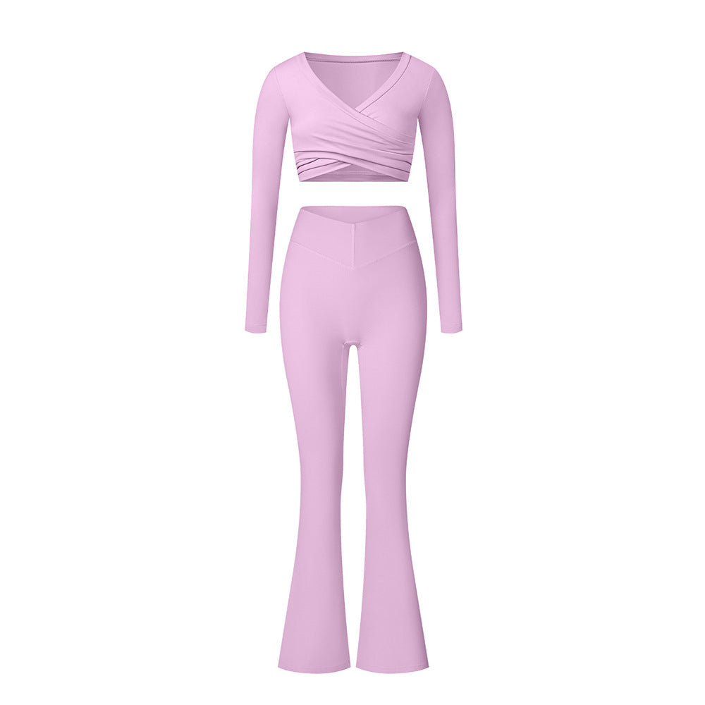 Pink workout set with long sleeve wrap top and flared pants, displaying seamless construction and stretchy material