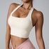 Model wearing cream-colored halter crop top with square neckline, paired with dusty rose high-waist leggings on light background