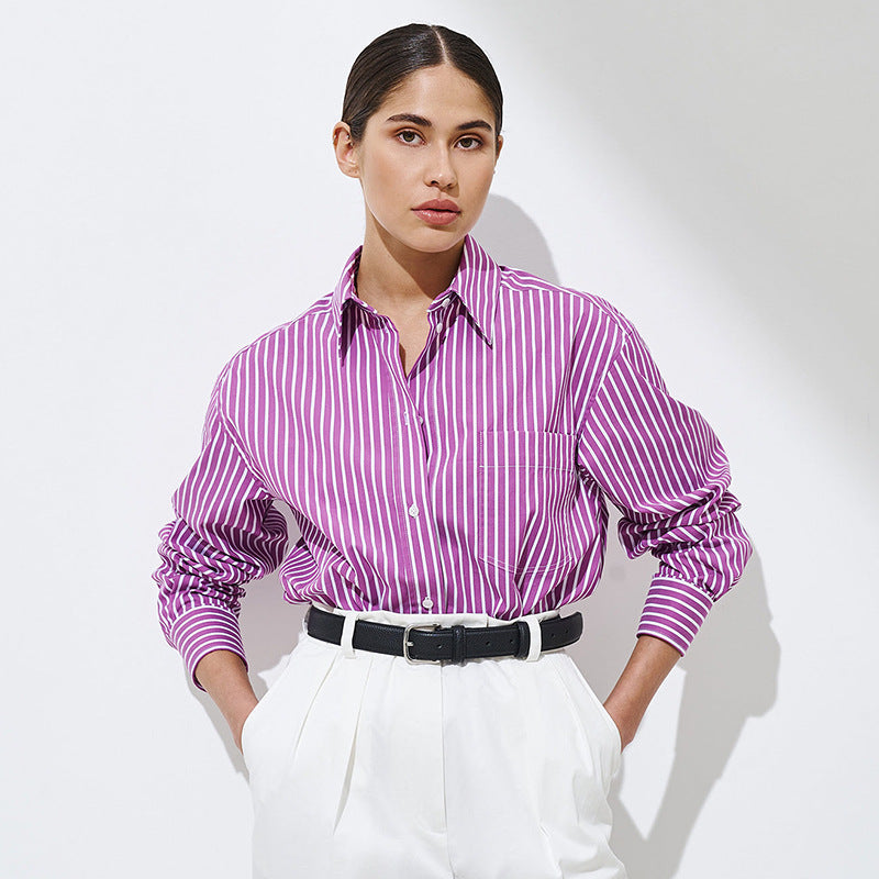 Woman wearing purple striped shirt tucked into white high-waisted pants
