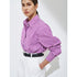 Side view of woman in purple striped shirt and white pants