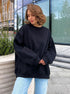 Black oversized crewneck sweatshirt paired with light wash denim, shown in urban setting