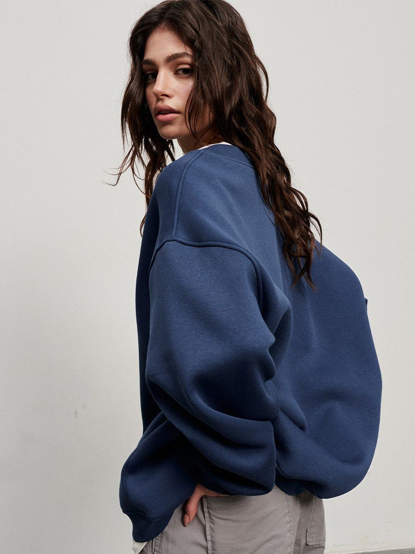 Navy blue oversized sweatshirt with dramatic balloon sleeves and white trimmed neckline