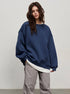 Navy oversized sweatshirt paired with white undershirt and gray casual pants