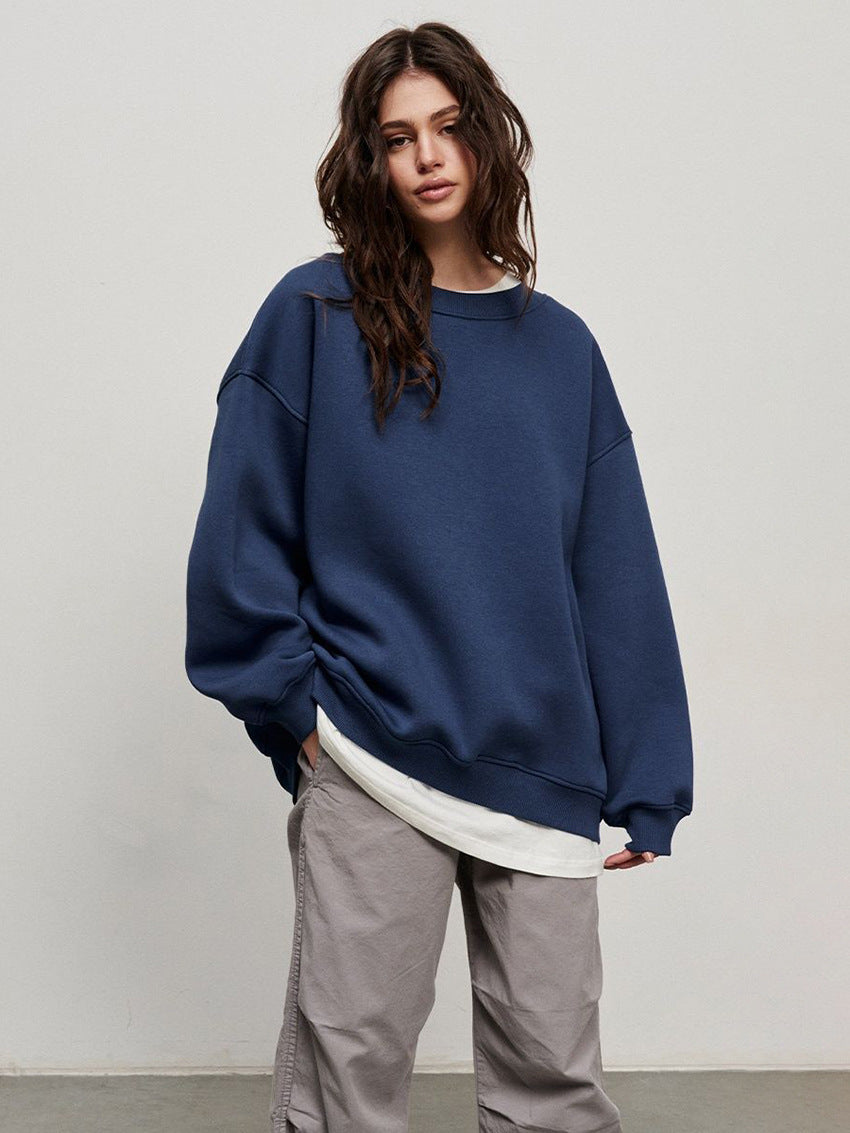 Navy oversized sweatshirt paired with white undershirt and gray casual pants