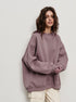 Mauve oversized sweatshirt styled with cream cargo pants and neutral makeup