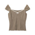 Taupe ribbed knit cap sleeve top with white contrast trim and bow detail at neckline, featuring scalloped hem displayed flat against white