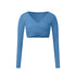 A powder blue long-sleeve wrap crop top with V-neckline and crossed front detail, shown flat against white background