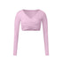A soft pink long-sleeve wrap crop top with V-neckline and crossed ruching detail, shown flat against white background
