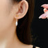 Two-tone gold and silver Water Drop dangle earrings on ear