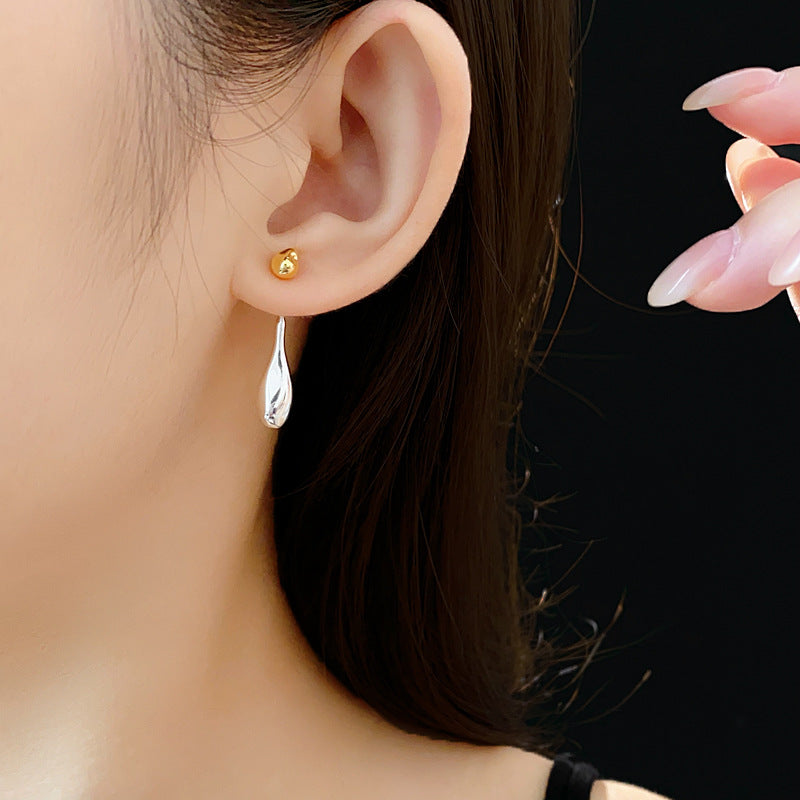 Two-tone gold and silver Water Drop dangle earrings on ear