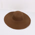 Dark brown wide-brimmed sun hat with a woven texture, displayed on a white surface.